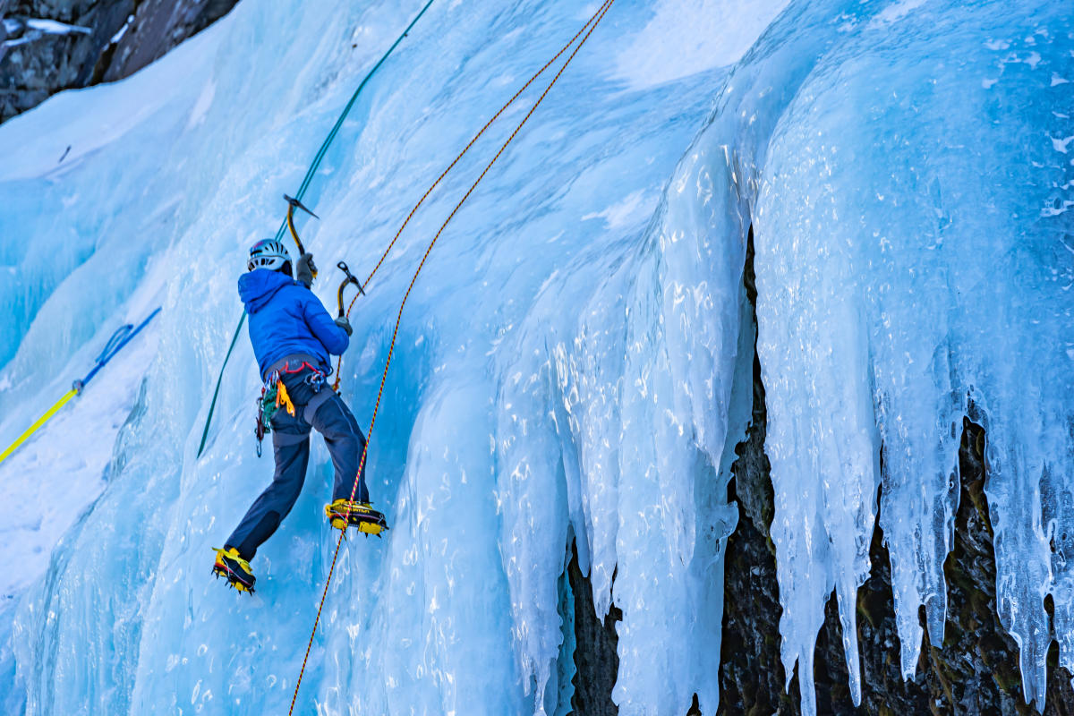 An ice climber on a frozen waterfall