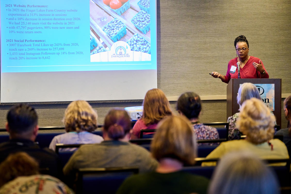 This is an image of a women presenting at a conference held at the Hilton Burlington in Burlington, VT