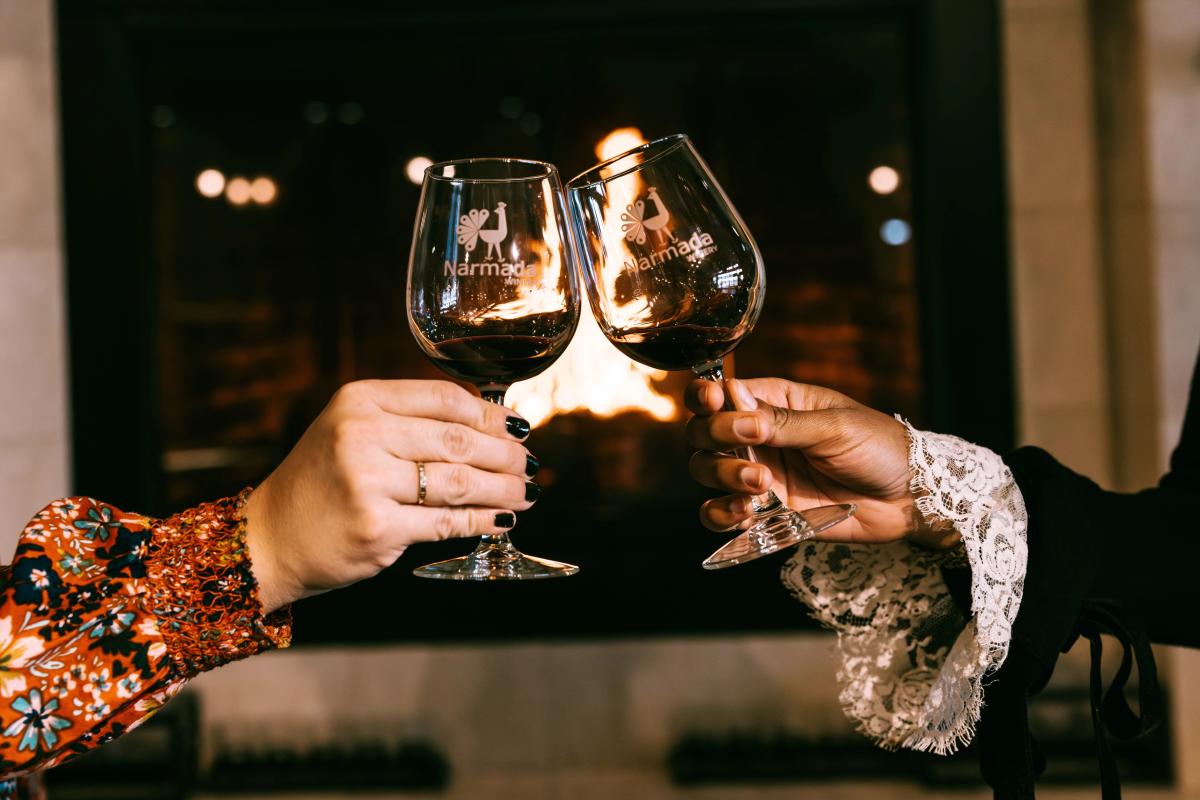 Narmada Winery Fireplace Two People Cheers with Wine Glasses