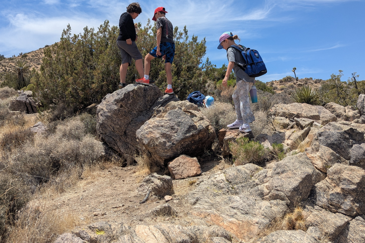 Children exploring rock formations in Joshua Tree National Park near Twentynine Palms, California.
