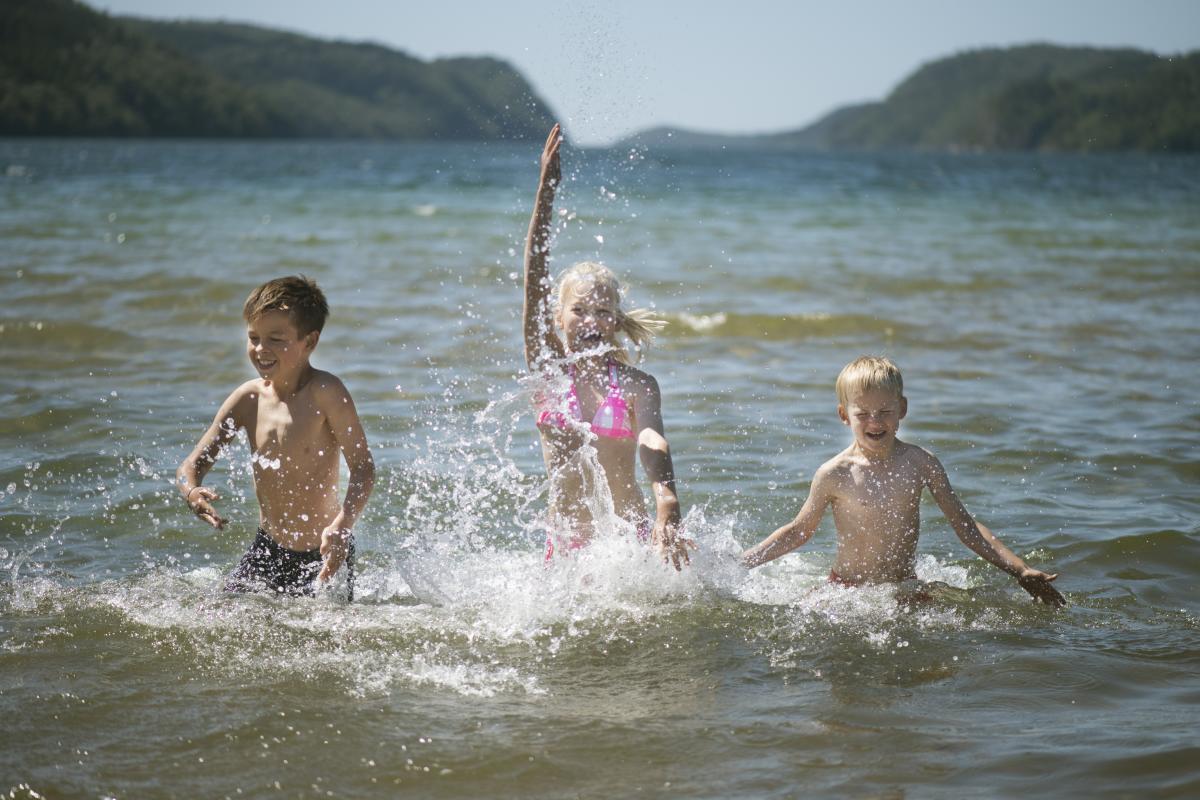 3 barn som leker i vannet
