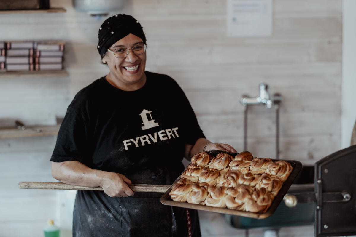 Kvinne holder nybakte boller fra Bakerovnen på Lindesnes fyr