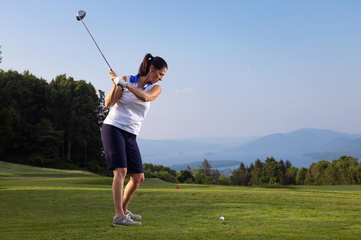 A woman golfing at Top of the World