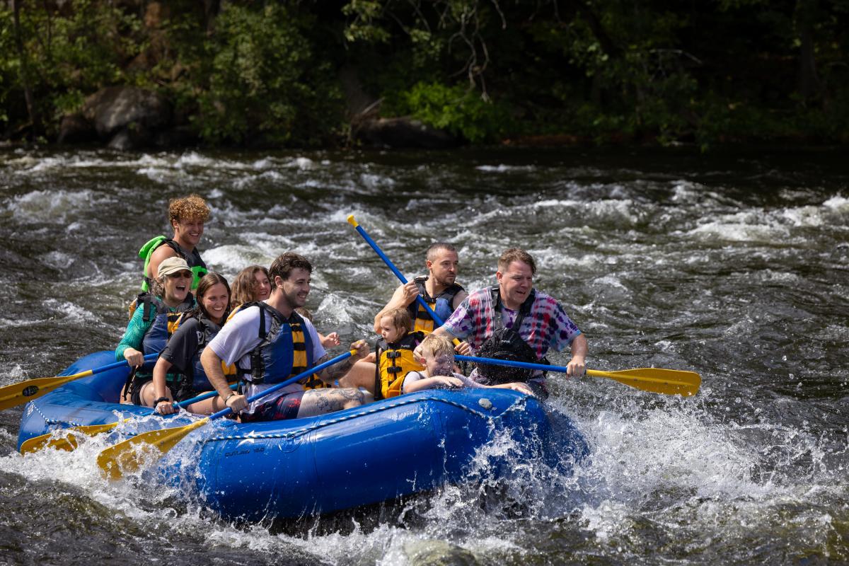 A group whitewater rafting with Adirondack Adventure Center