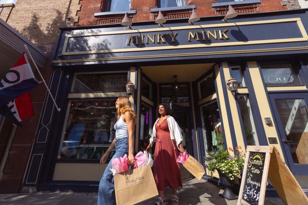 Women leaving Minky Mink with shopping bags