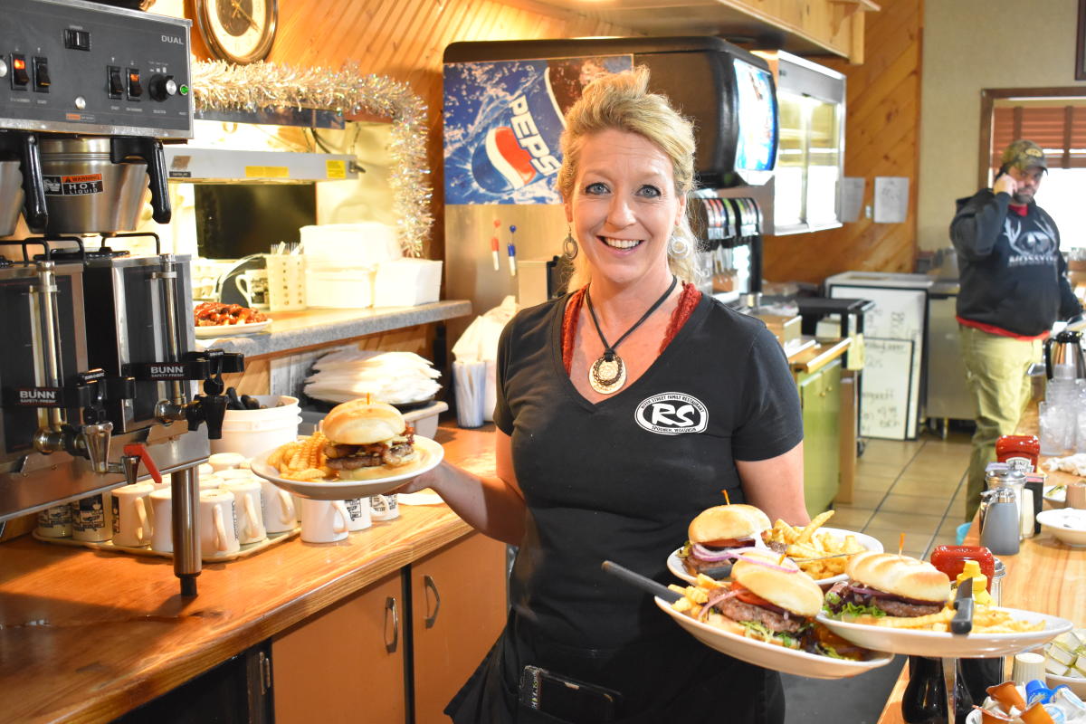 server holding breakfast at a family restaurant