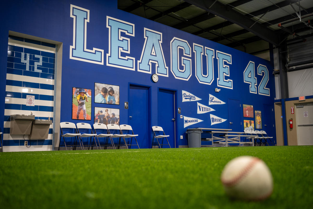 A sign reading League 42 is painted on a wall inside the facility in Wichita