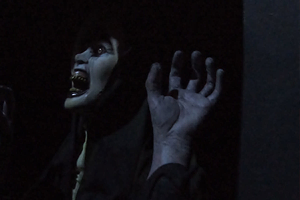 A ghoul screams at a haunted attraction