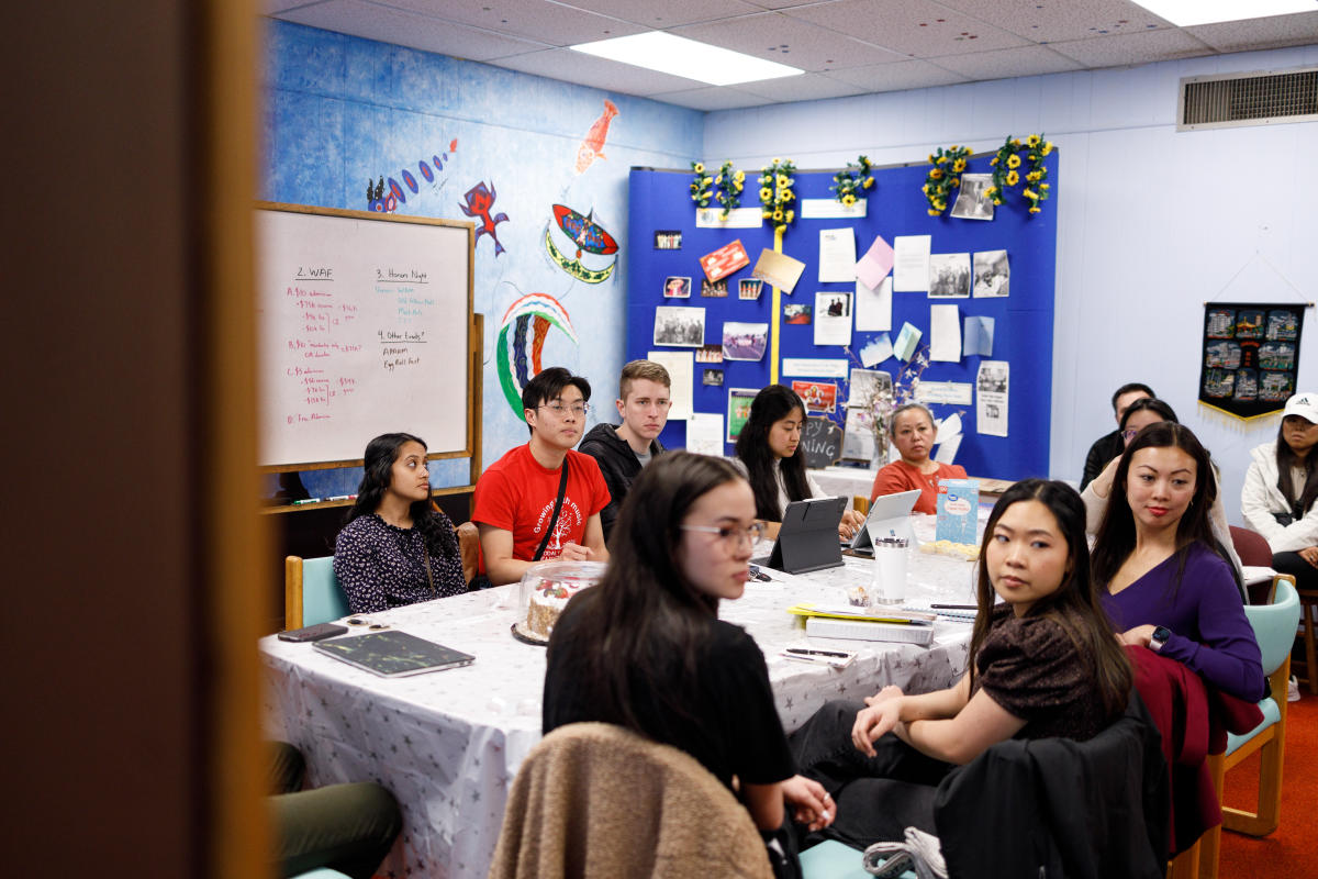 Members of the Wichita Asian Assocation sit at a table during a meeting