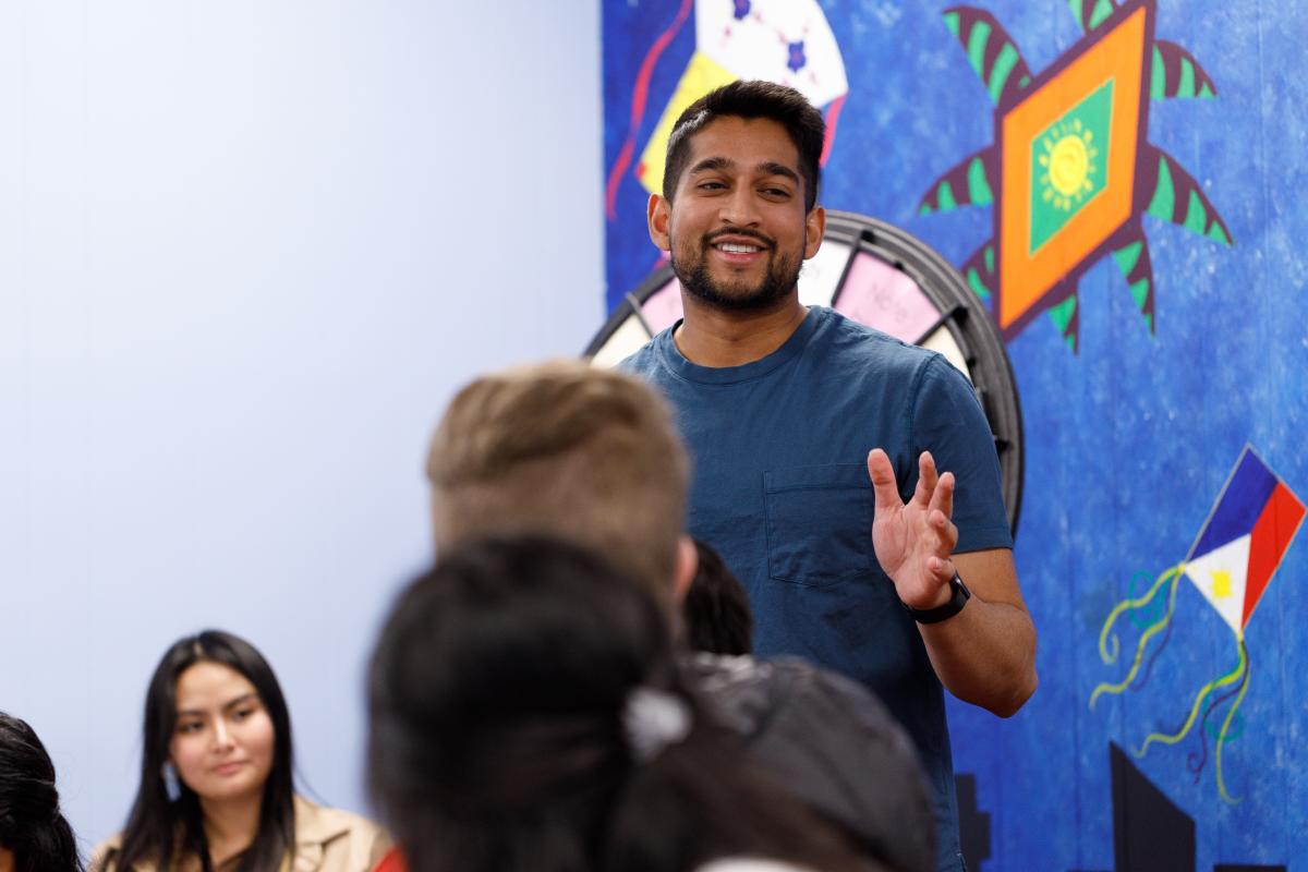 Taben Azad, president of the Wichita Asian Association talks to members during a meeting