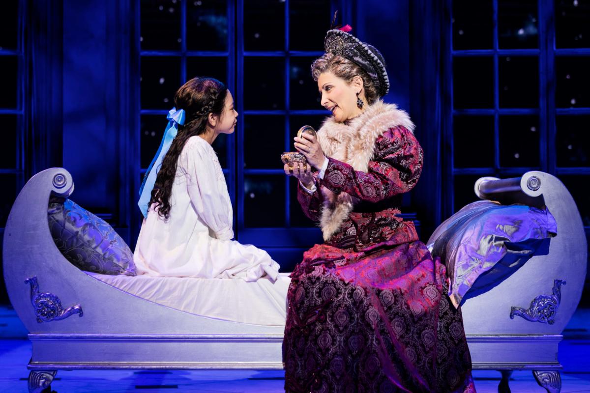 Two cast members - an older woman and young girl - perform in a scene in the musical Anastasia