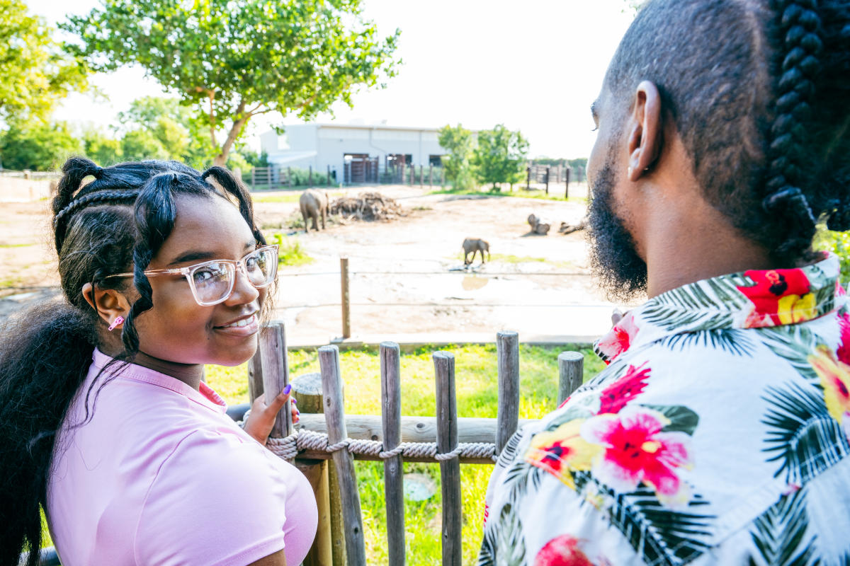 A girl and boy look at the elephants at the Sedgwick County Zoo