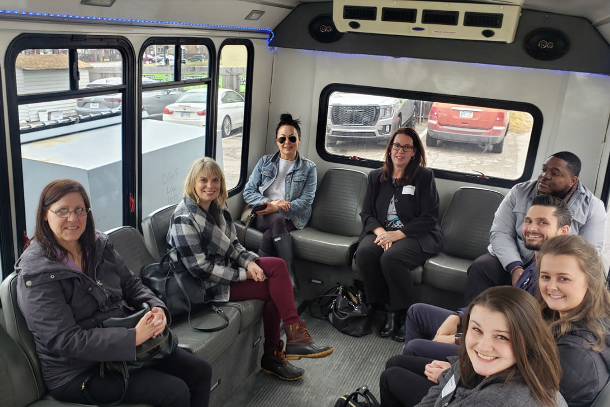 A group of professionals rides through Wichita on a Brew Wagon Tour bus