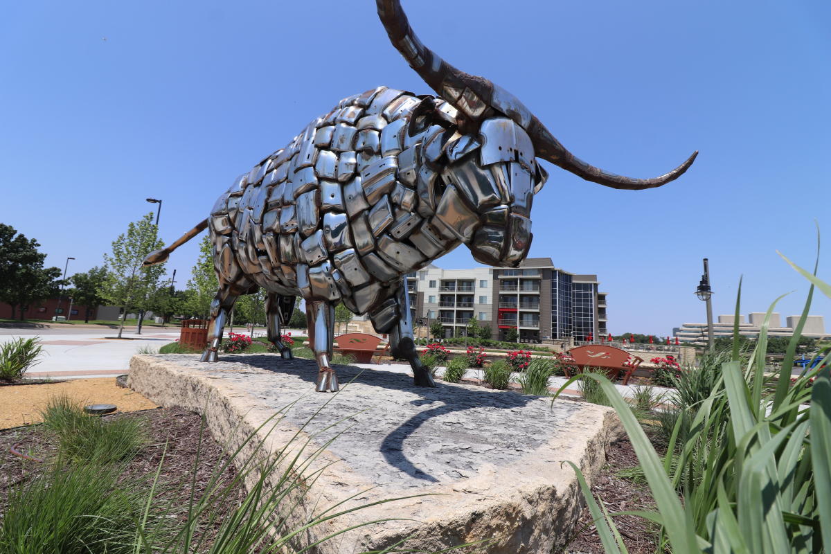 A sculpture made of shiny car bumpers sits on display in downtown Wichita.