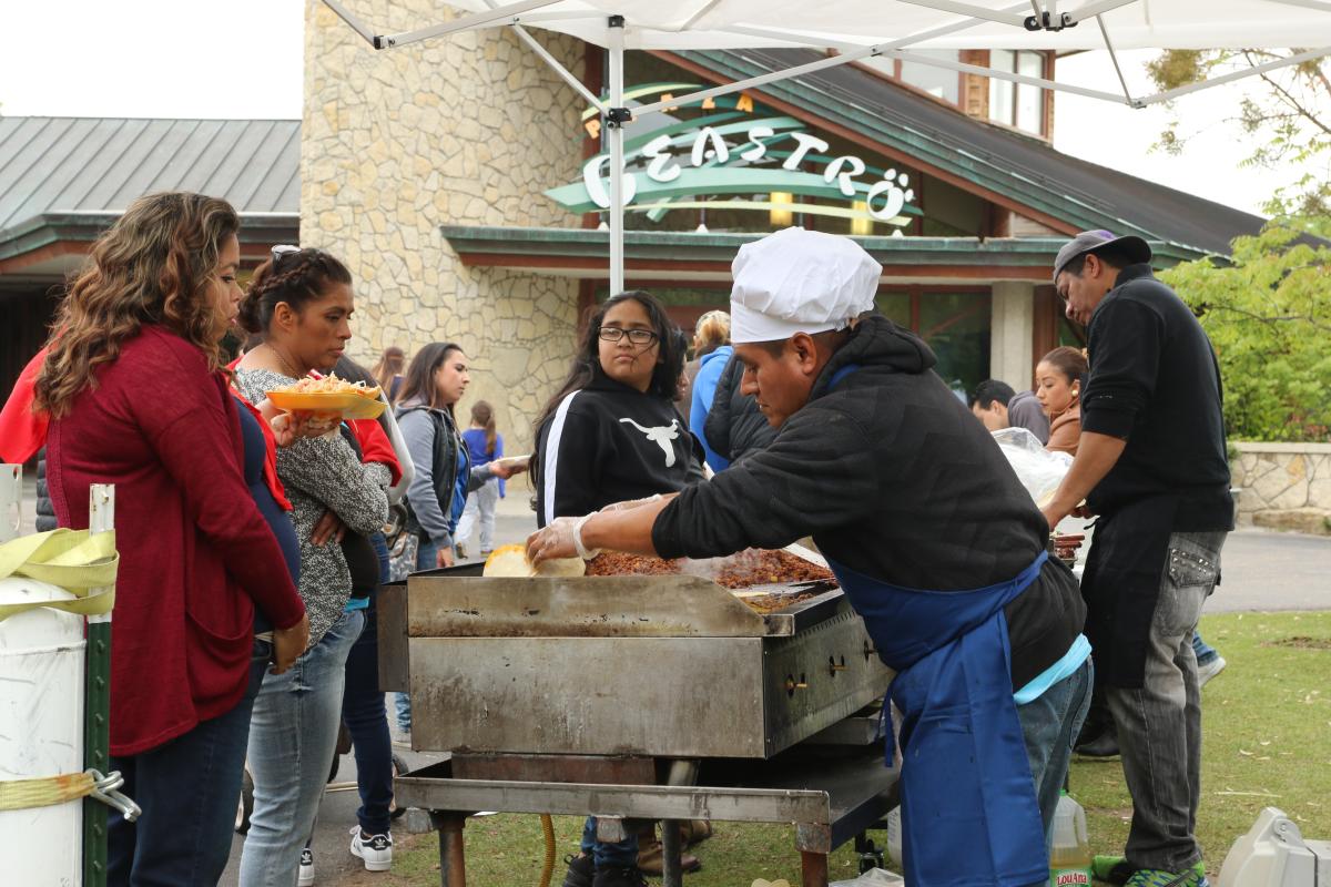 People are served Mexican food during the Cinco de Mayo celebration at the zoo