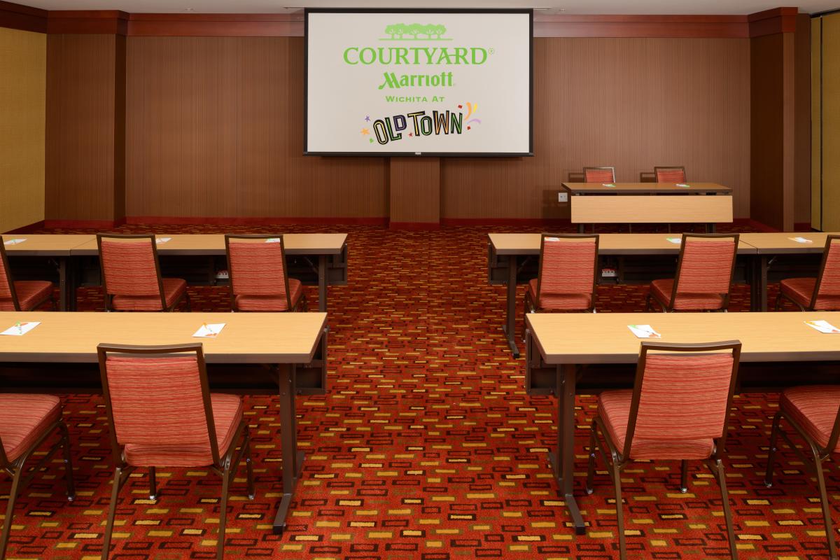 Chairs are set up at tables in a metting room at Courtyard by Wichita Marriott at Old Town