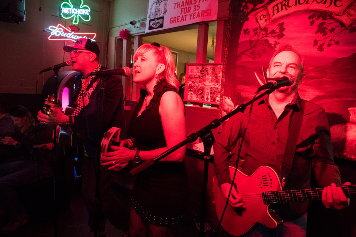 Members of a band perform on stage at Artichoke Sandwich Bar