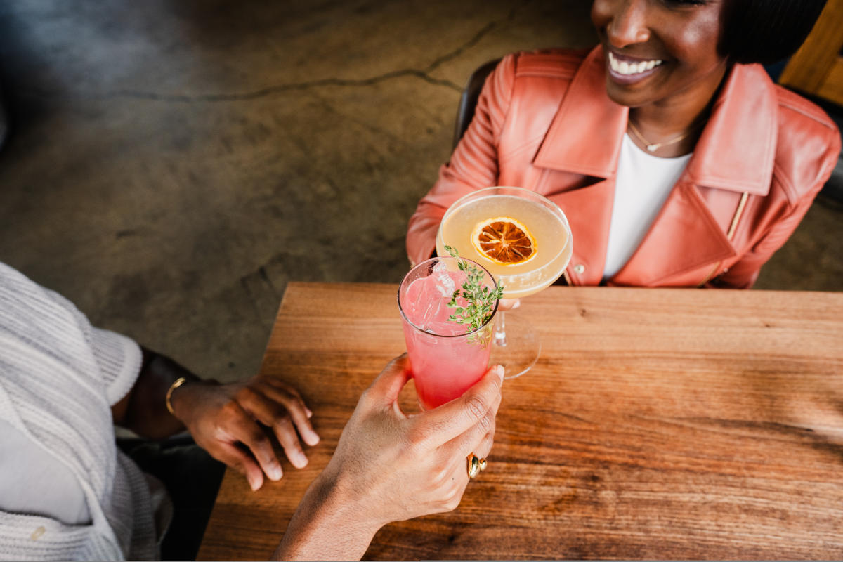 A couple enjoys drinks at The Belmont.