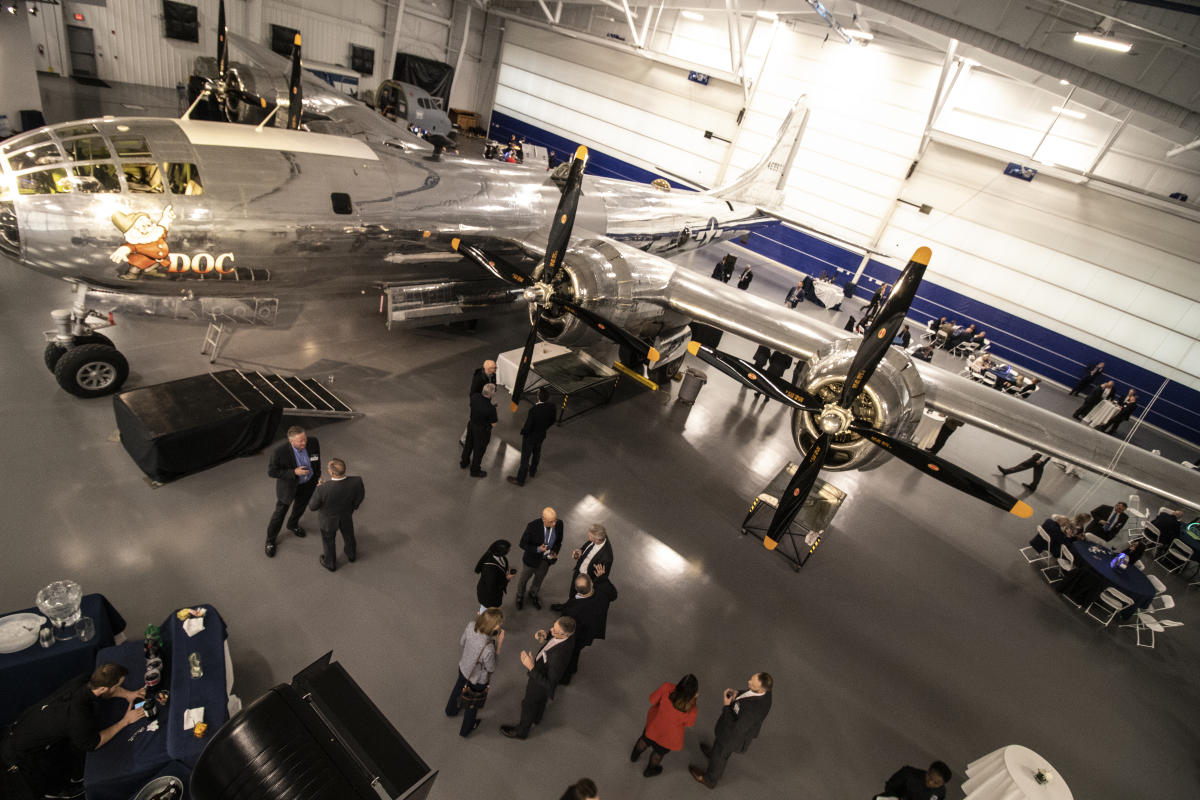 Meeting attendees network at an event at the B-29 Doc Hangar, Education & Visitors Center