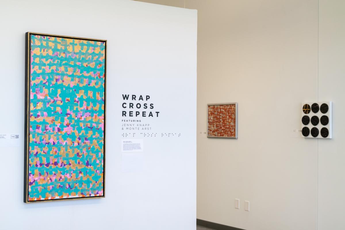 Artwork from the "Wrap, Cross, Repeat" exhibit sits on display at Envision Arts Gallery