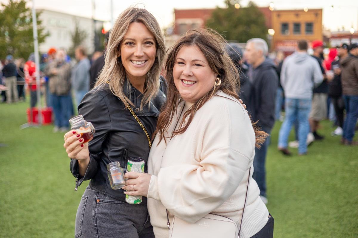 Two women pose for a photo smiling at Naftzger Park