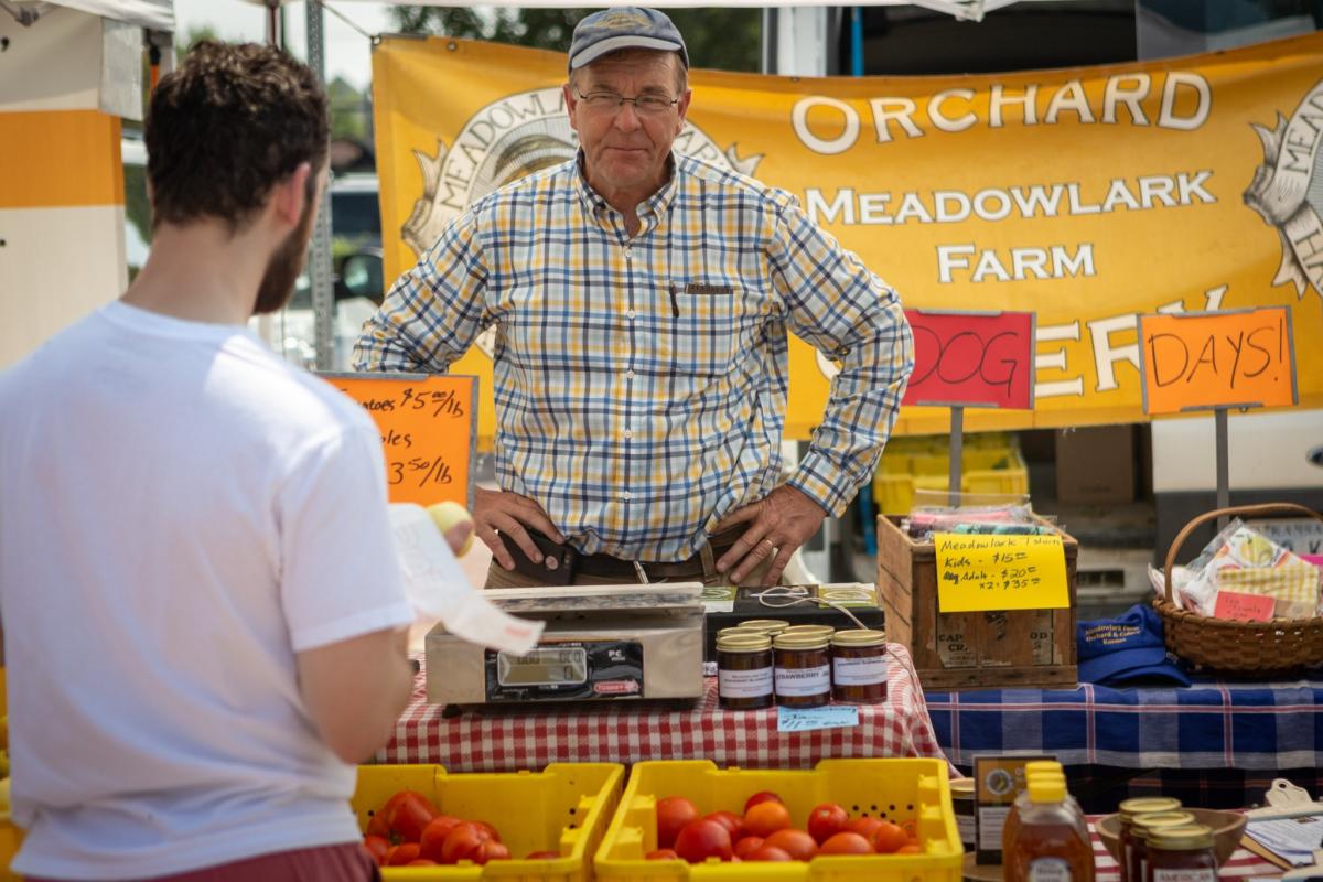 A man shops produce from a vendor at the Farmers Market in Wichita