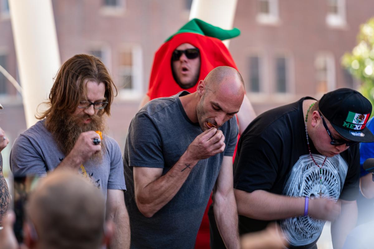 Men compete in the chili-eating contest at the Wagonmasters Downtown Chili Cookoff