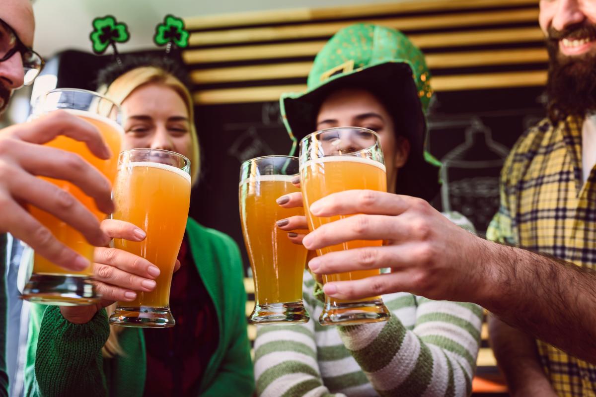 A group of people raise their glasses of beer during a St. Patrick's Day Event in Wichita