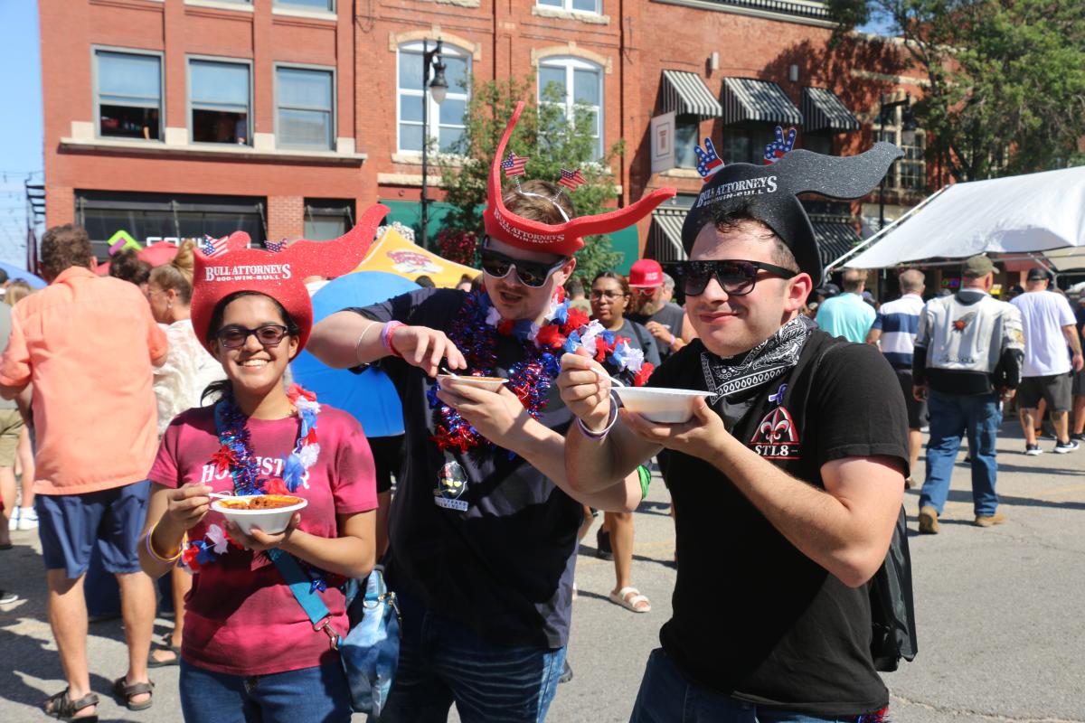 Three people taste chili during the Wagonmasters Downtown Chili Cookoff in Wichita