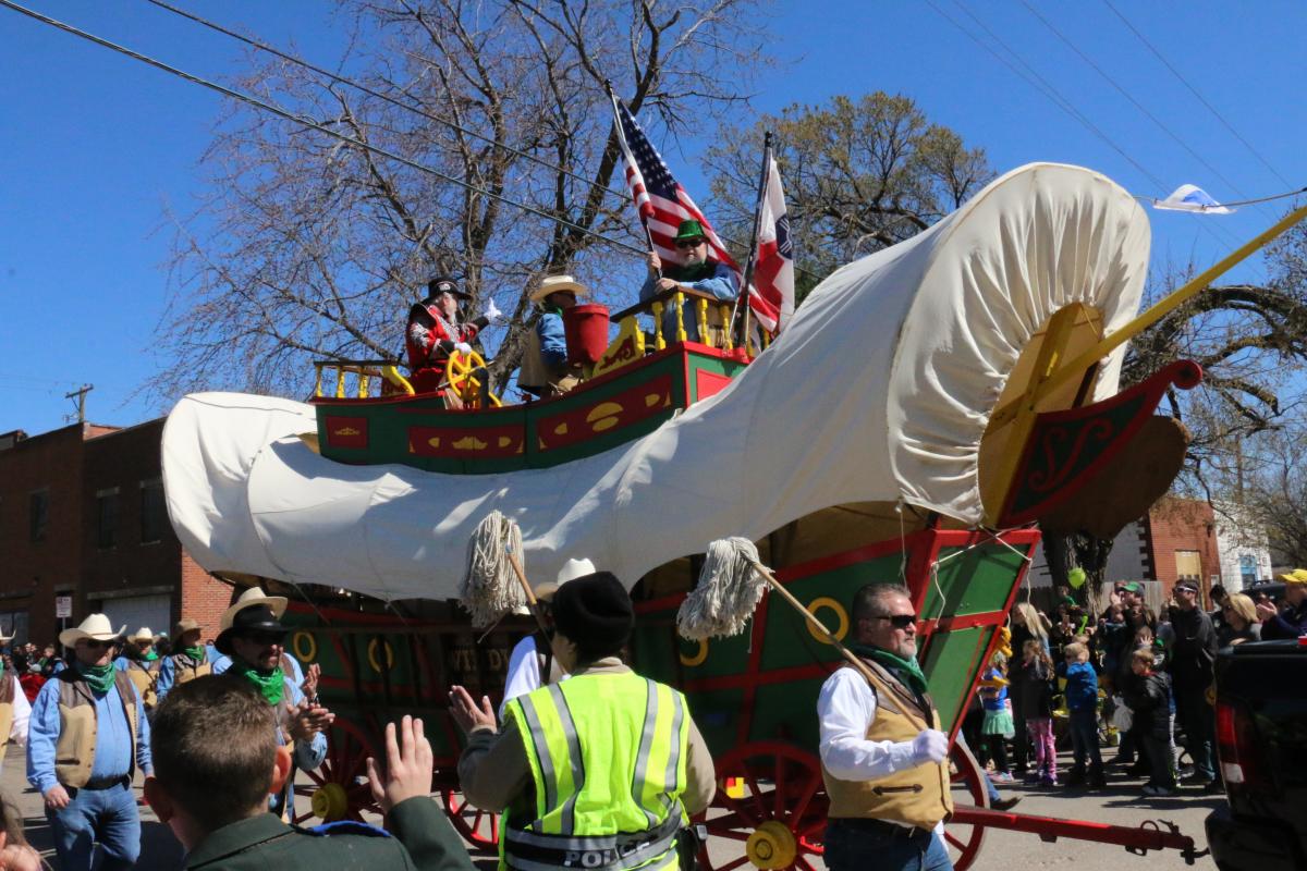 Two men ride the Windwagon in the Delano Paddy Day Parade