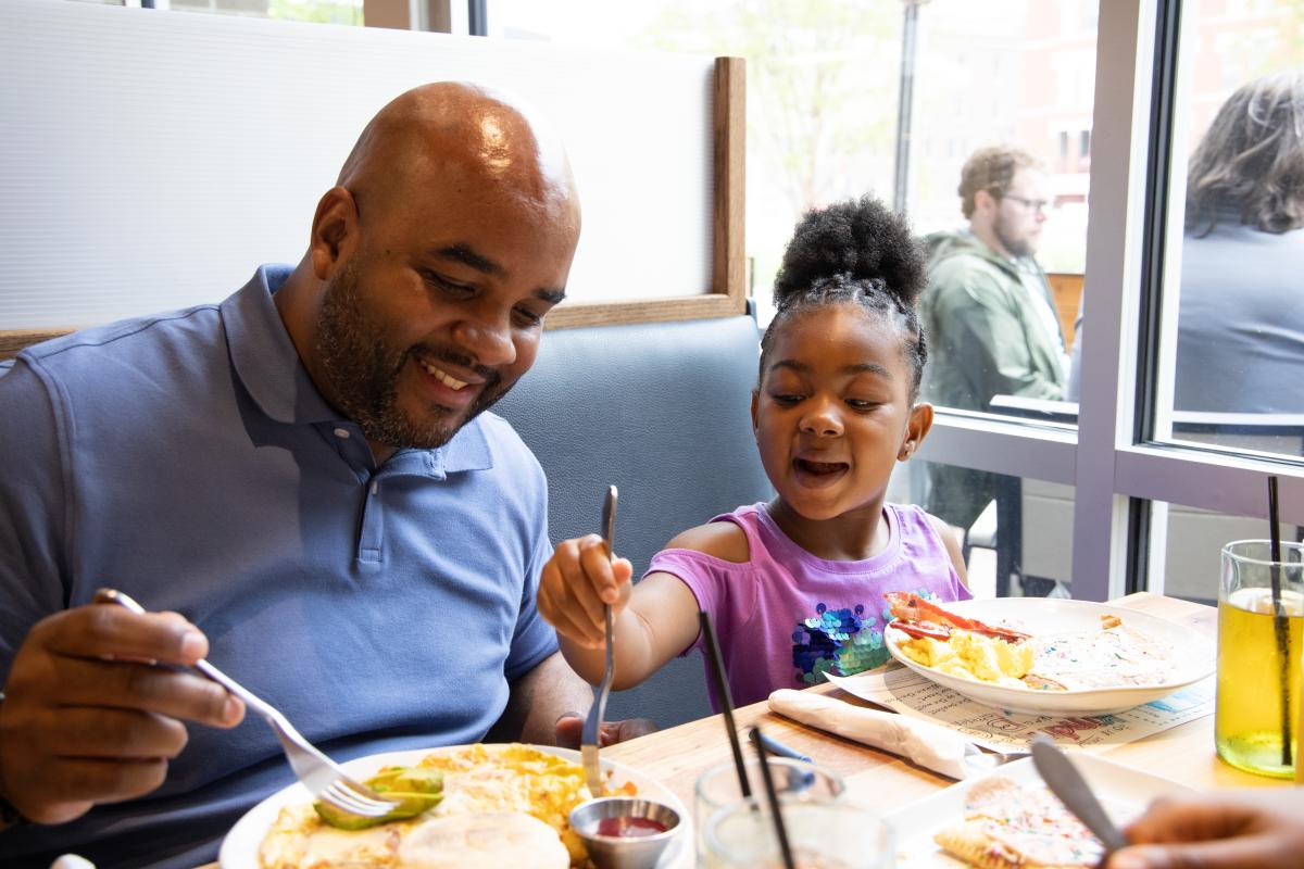 A man and his daughter enjoy a meal at Homegrown