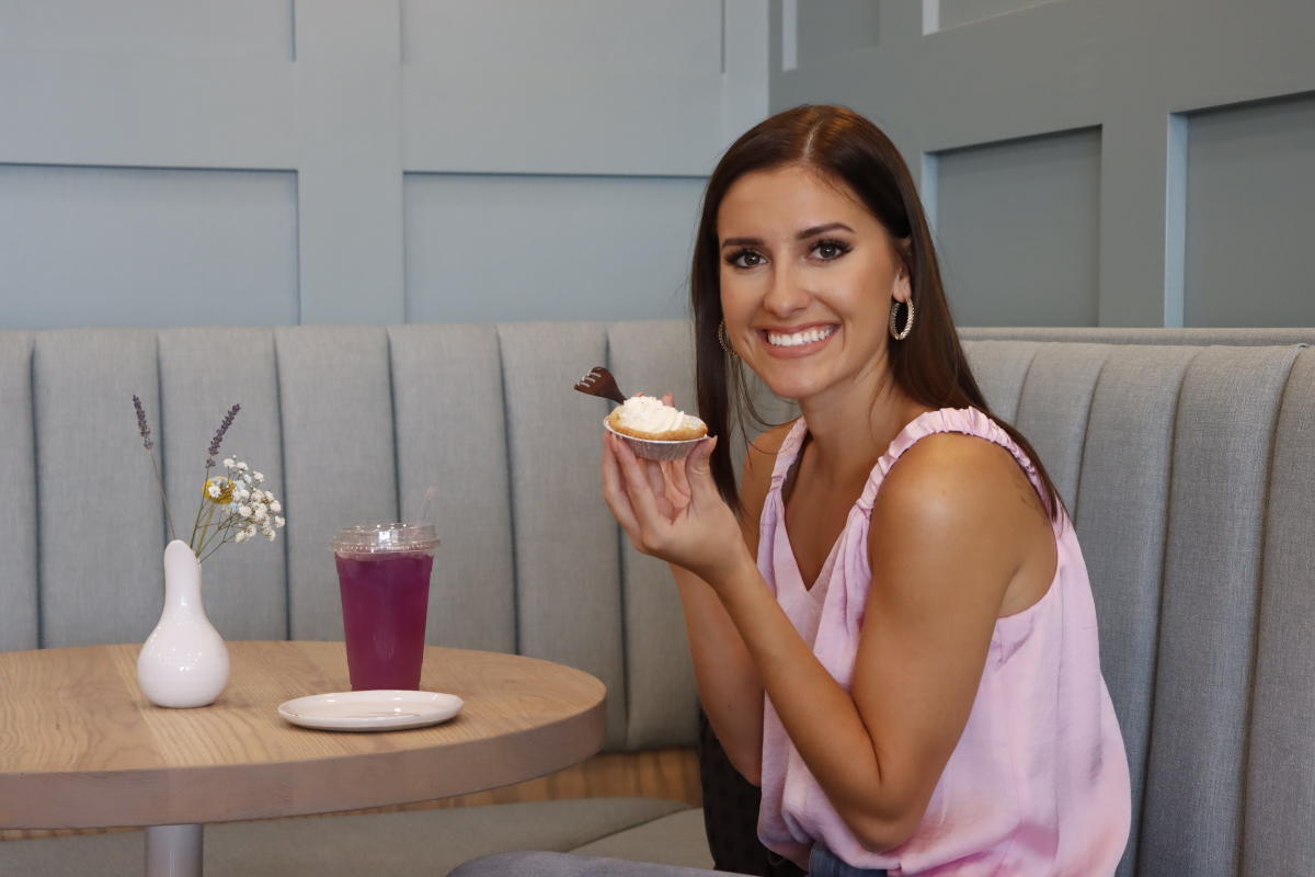 Miss Kansas takes a photo with a small personal pie at Bakesale Treat Parlor.