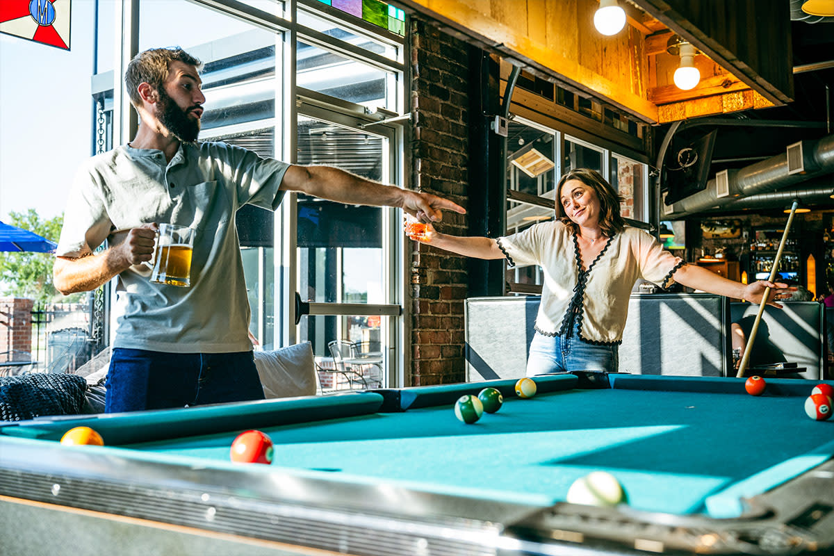 A couple enjoys a pool game at The Monarch