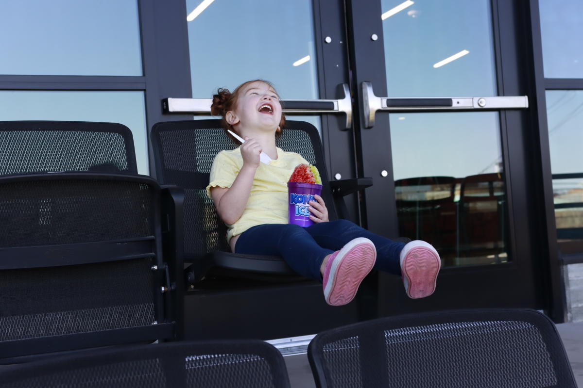 Small girl enjoys a Kona Ice shaved ice at Riverfront Stadium