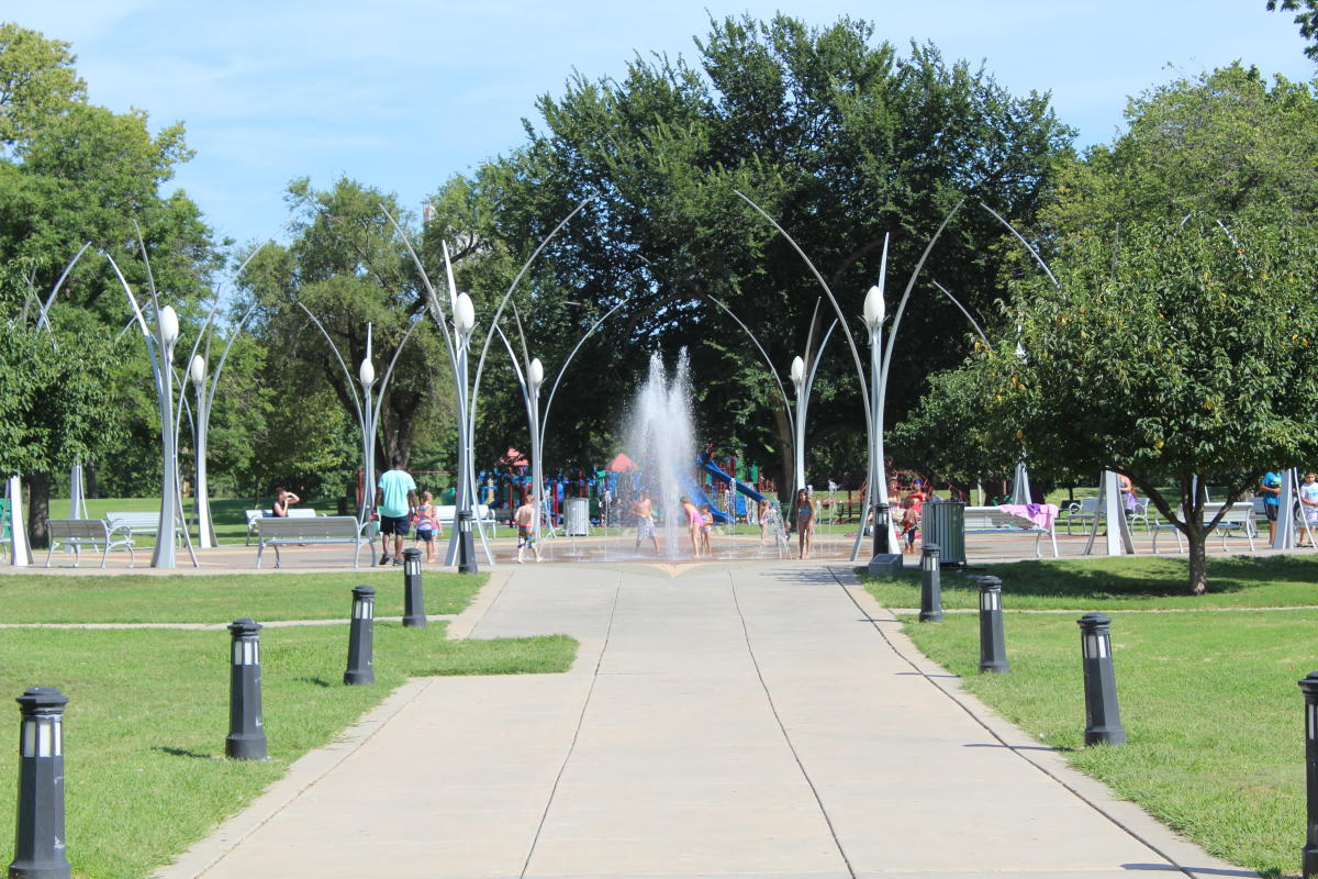 Kids play on a hot day at the splash pad at Riverside Park In Wichita, KS