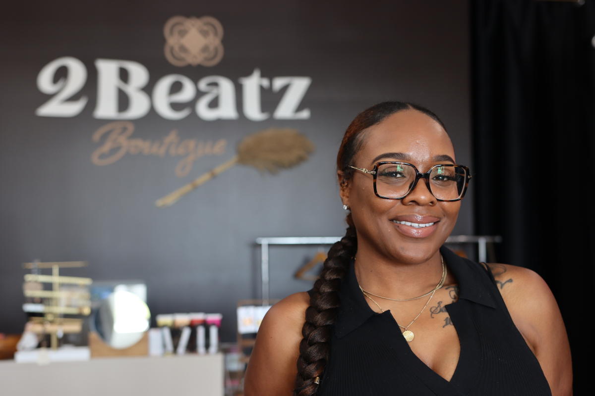 The owner of 2 Beatz Boutique poses for a photo in her shop
