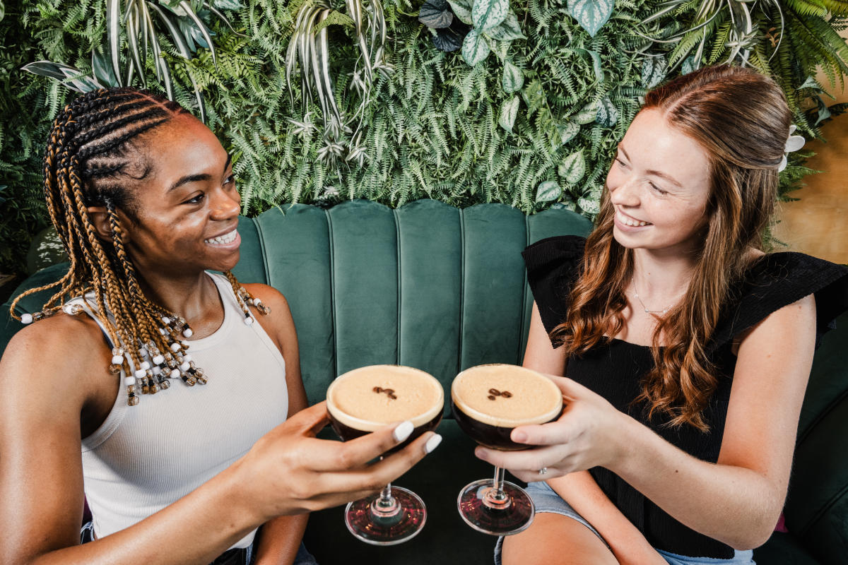 Two young ladies toast martinis at GROW Plant Bar.