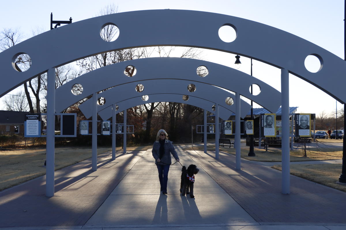 A woman walks her dog at Redbud Trail