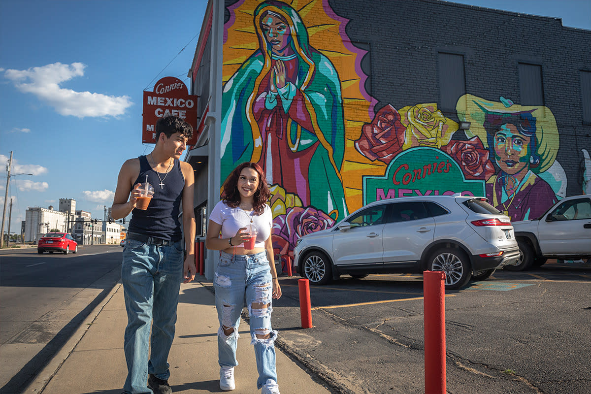 A young Hispanic woman and man walk through the NOMAR district in Wichita