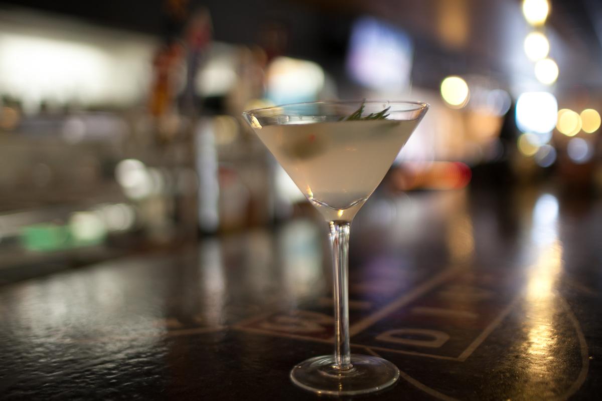 A cocktail is served in martini glass on the bar at Wine Dive