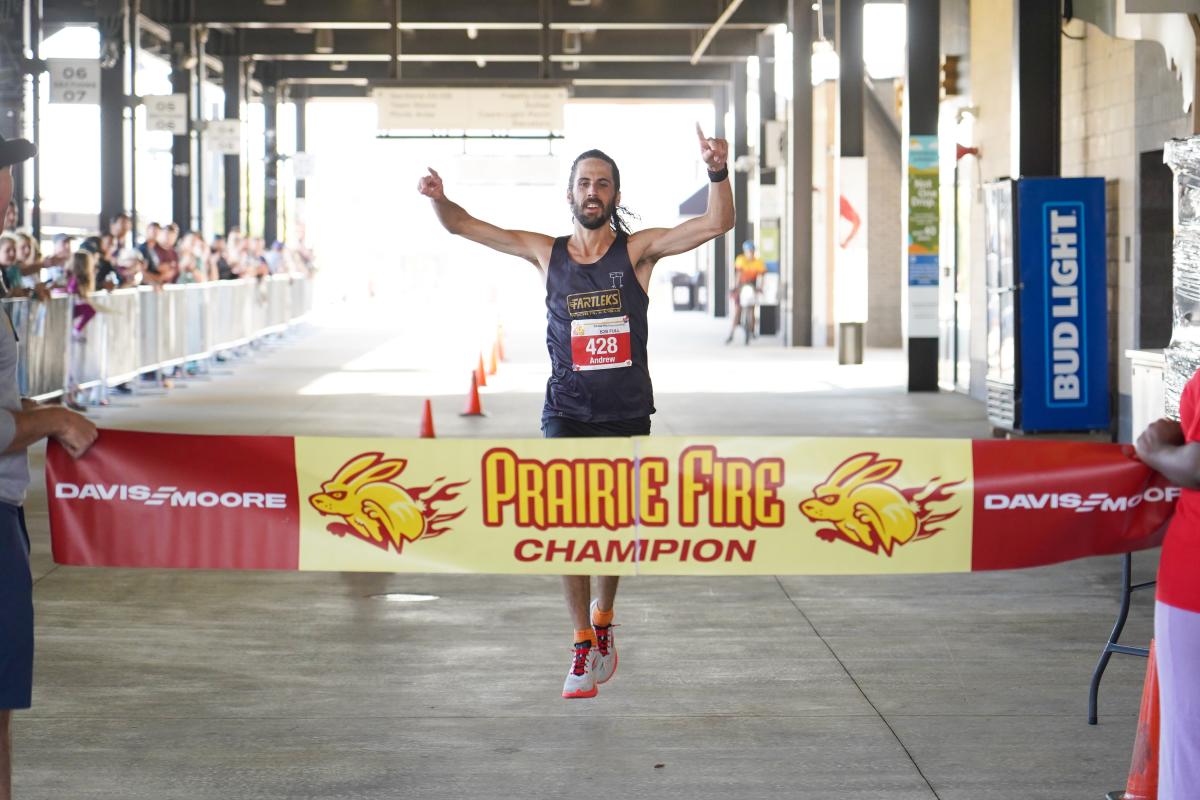 Man crossing finish line at Prairie Fire