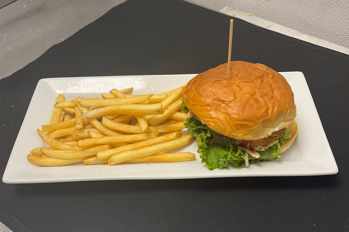 The Hawaiian Chicken Sandwich is served with a side of fries at Dave and Buster's