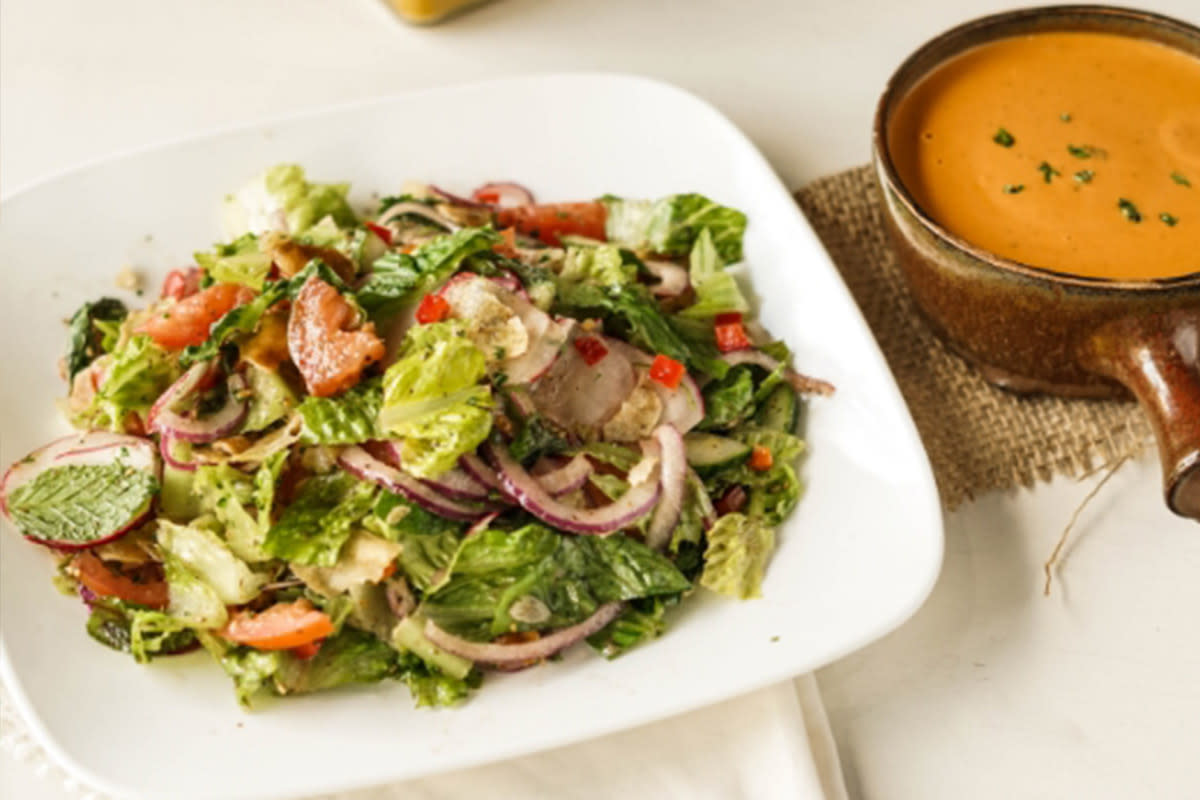 The fattouch salad at Meddys is served alongside a hot cup of tomato bisque soup