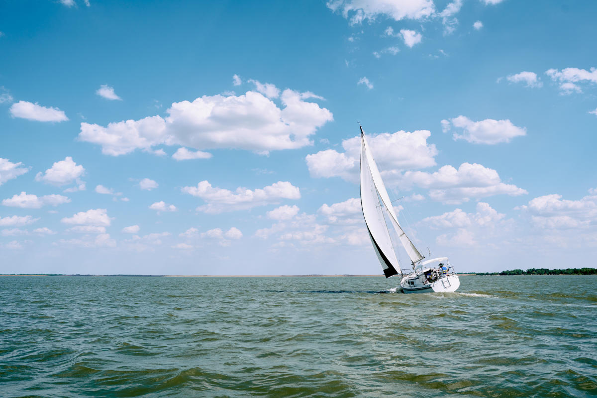 A sailboat floats on the water at Cheney State Park