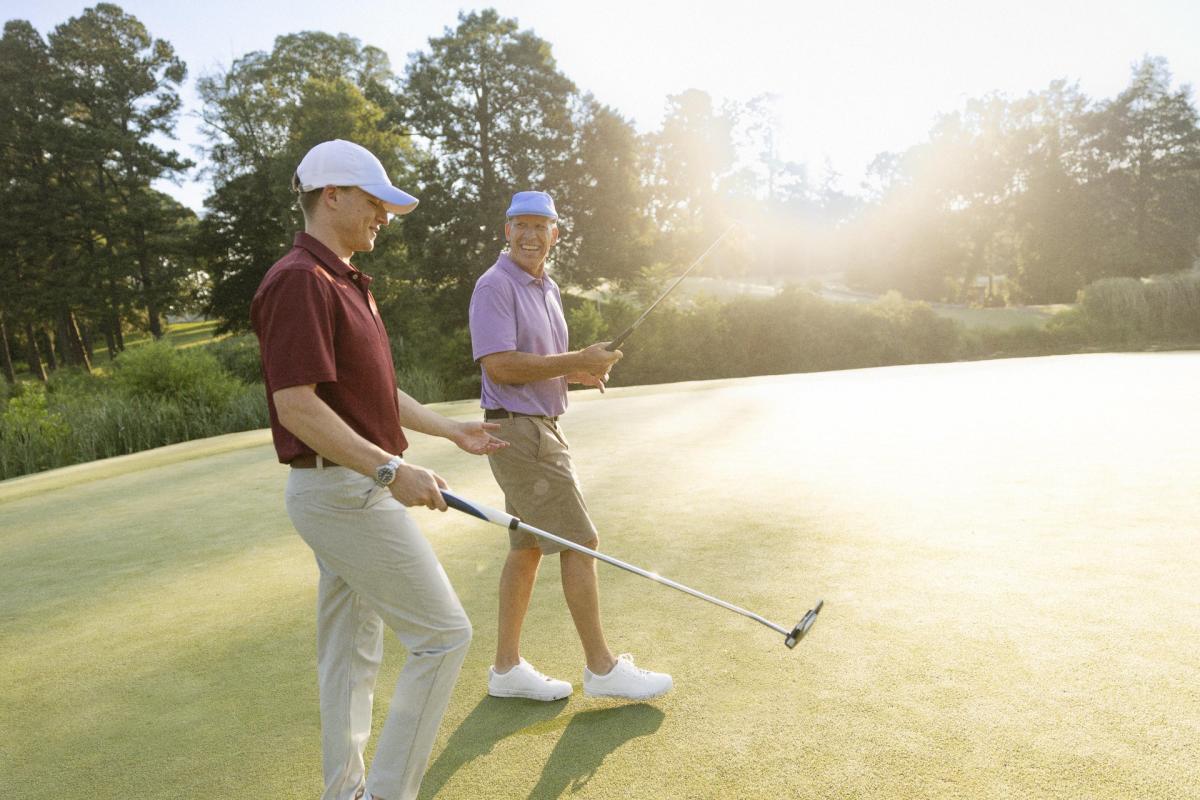Two Men Golfing at the Golden Horseshow