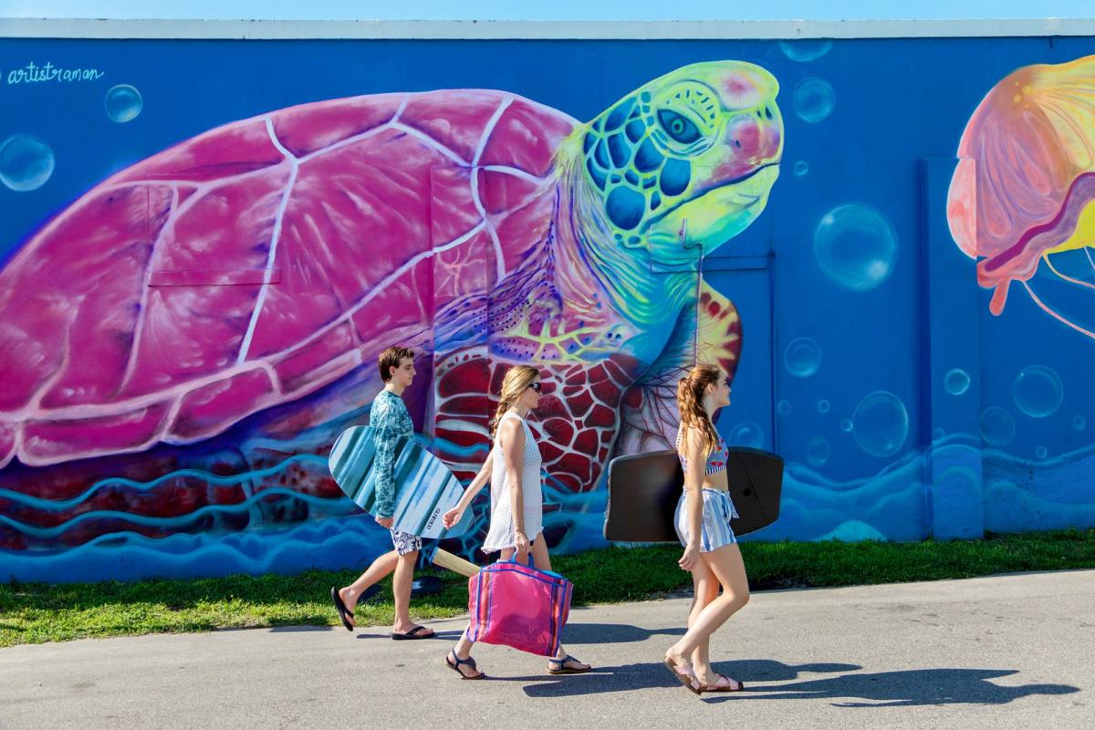 Family walking by Marine Magic Carolina Beach Mural