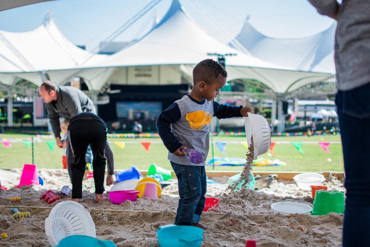 Boy playing in the sand during The Children's Festival at The Cynthia Woods Mitchell Pavilion
