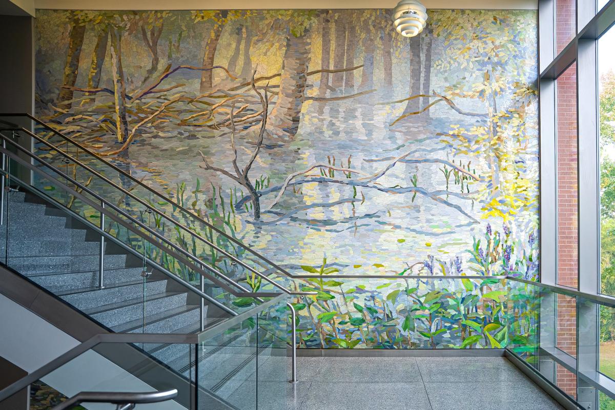 Reflections to Mist Mosaic in Stairwell at Sam Houston State University - The Woodlands. The full art piece is 4 stories tall, wrapping around the interior and exterior of the building. This segment (3rd floor?) depicts a marshy landscape in the early morning with mist rising over the water.