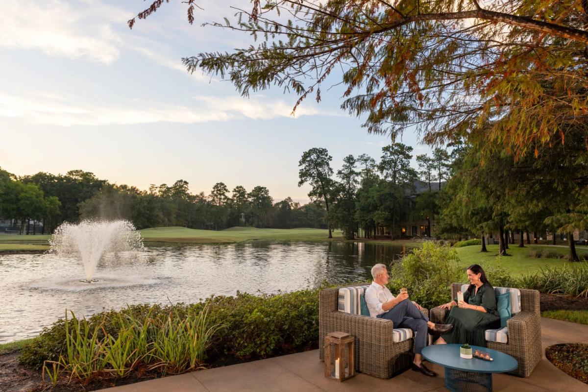 Couple enjoying cocktail by Lake Harrison at The Woodlands Resort in The Woodlands, Texas
