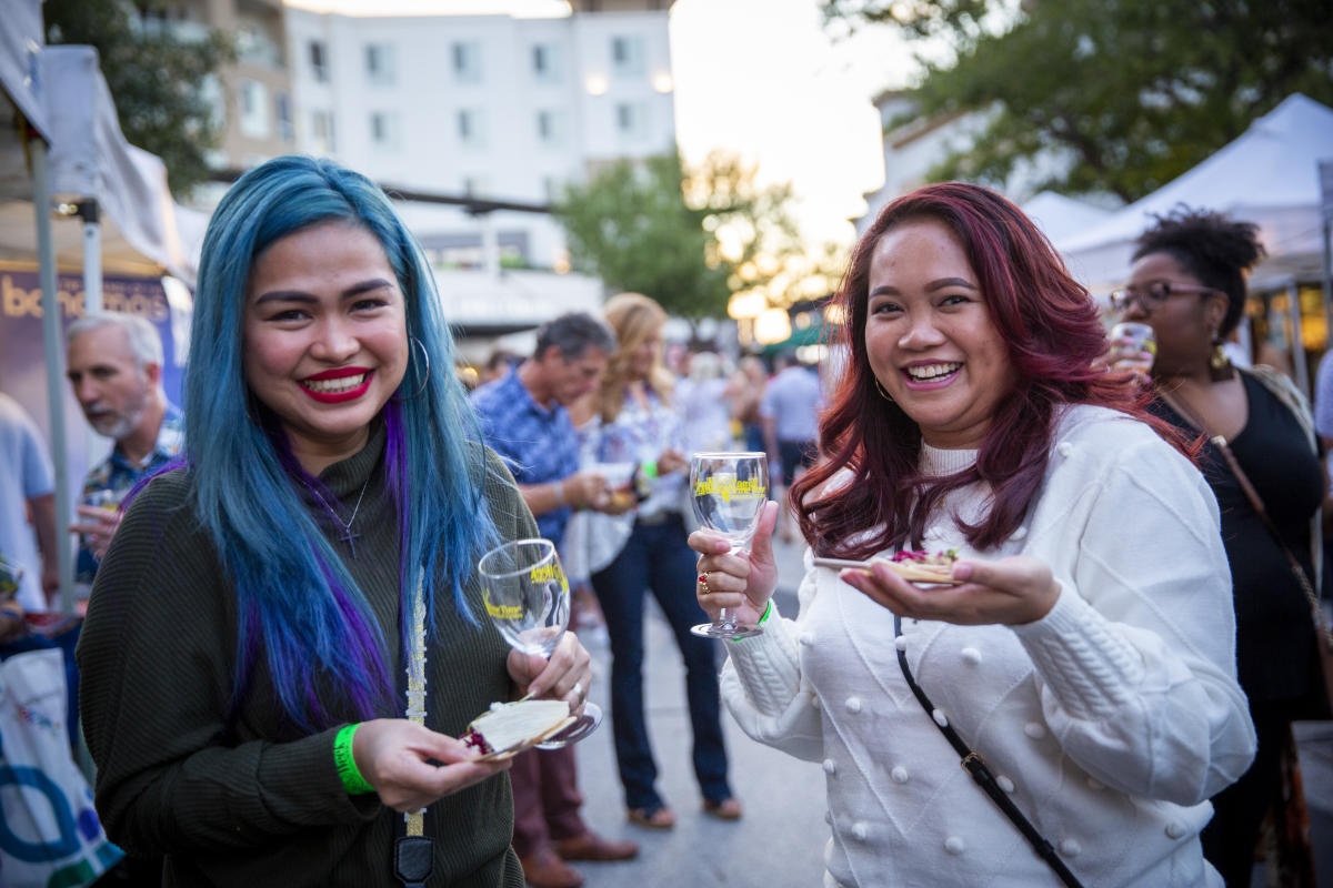 Two girls enjoy a glass of wine during The Woodlands Food and Wine Week Wine Walk
